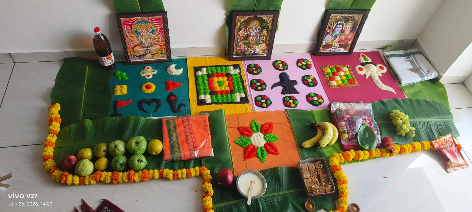 North Indian home puja setup with multiple deity pictures and offerings
