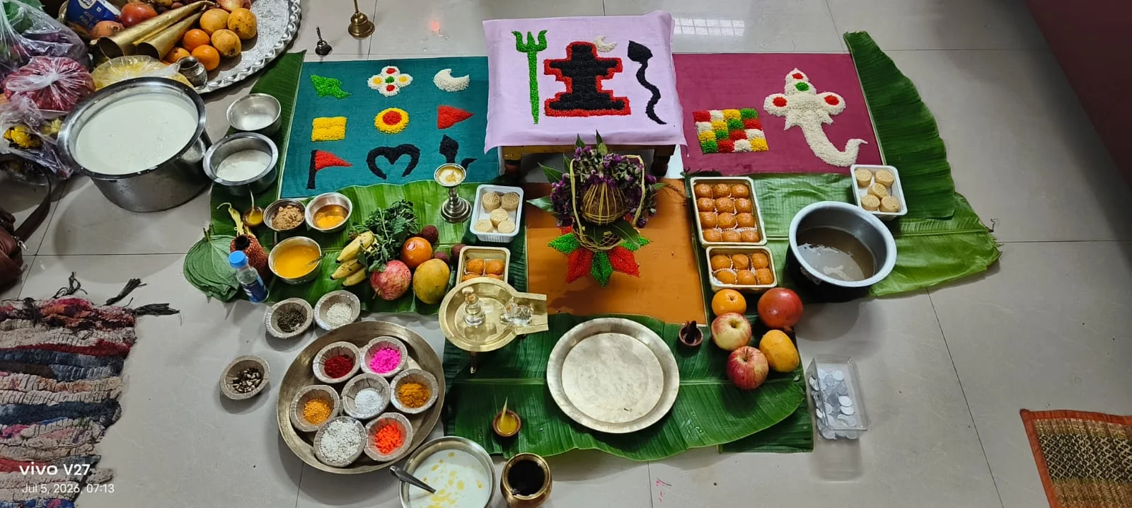 Puja samagri, rangoli and offerings prepared on banana leaves